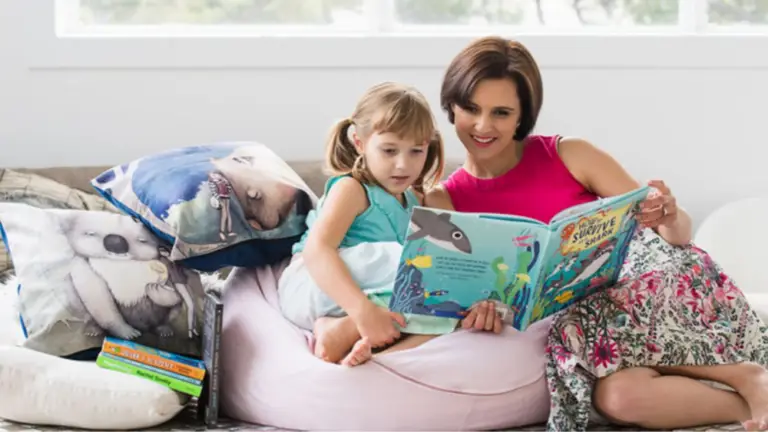 a mother reading ocean adventures to her little girl