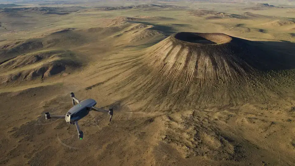 drone flying around a crater