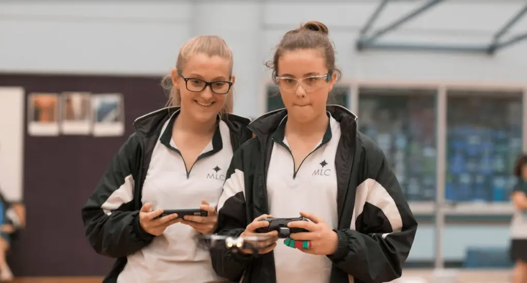 Two girls engaged in a She Maps drone education program
