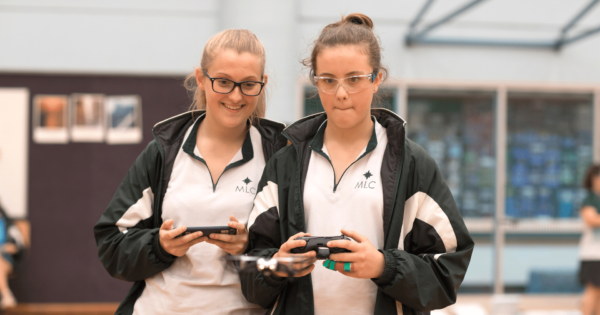 two female students from MLC engaged in their indoor drone lessons