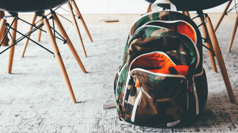a school backpack sits on the ground in a classroom