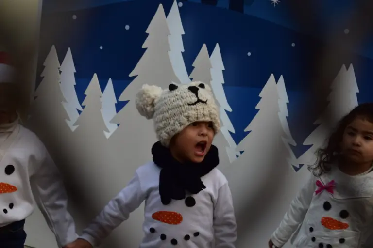 a kid performing a song during a holiday program