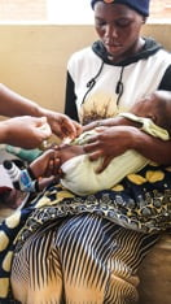 a black mother with her infant receiving medical attention