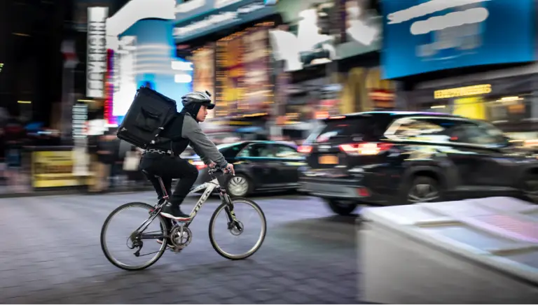a food delivery man on his bike in the city