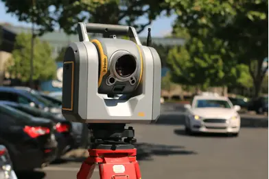 a tripod and scanner by the roadside
