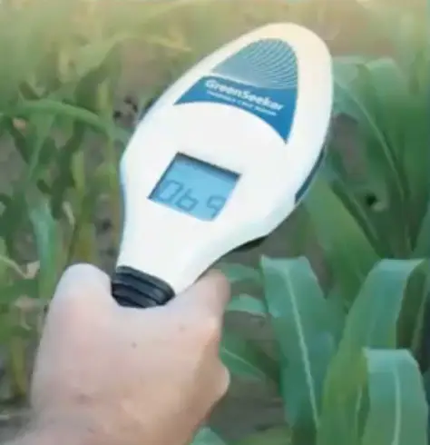 Teaching Agriculture with drones a man holding an agri tech tool called GreenSeeker