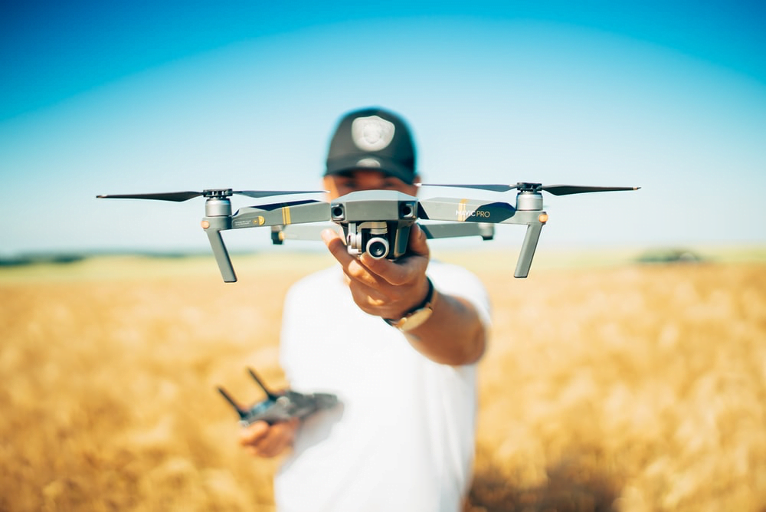 Teaching Agriculture with drones a man holding up a drone outdoors