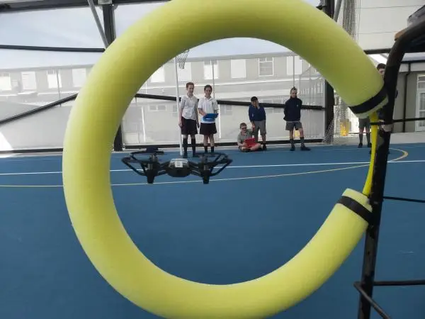 Students flying drone with an obstacle
