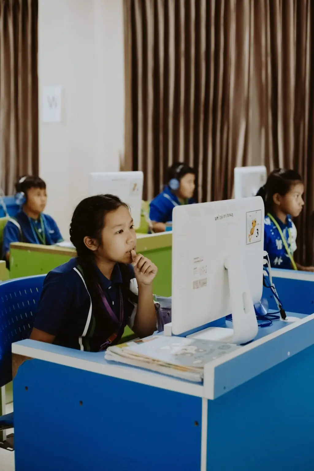 She Maps students in front of their desktop