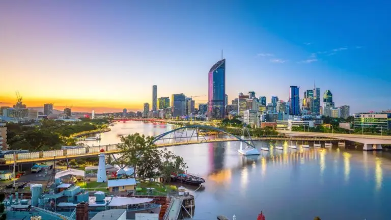 Brisbane city skyline at sunset with river view.