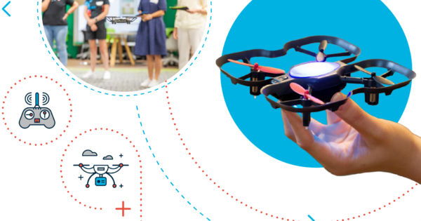 Hand holding a small drone indoors.