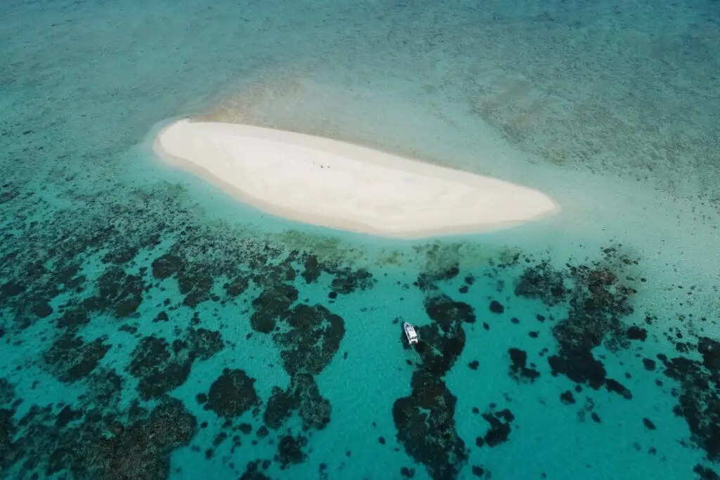 Aerial view of remote sandbar and coral reef.
