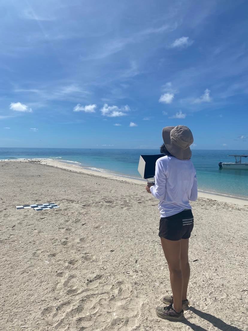 Person holding box on sunny beach
