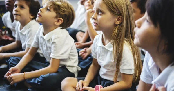 kindergarten students sitting on the floor