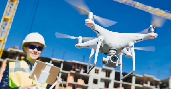 drone operated by construction worker on building site