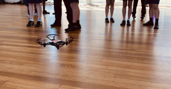 Students flying drones indoor