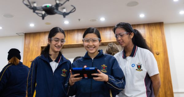 students learning to fly drones