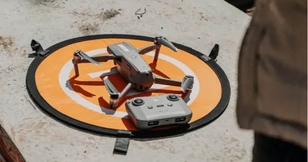 a drone and controller on top of an orange launch pad