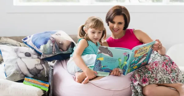 a mother reading ocean adventures to her little girl