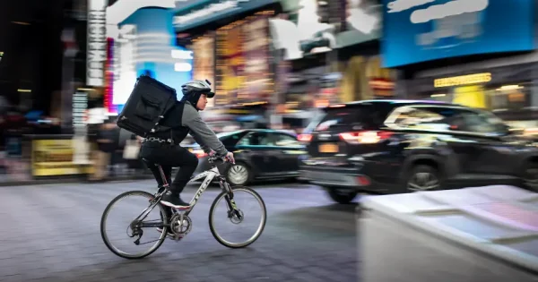 a food delivery man on his bike in the city
