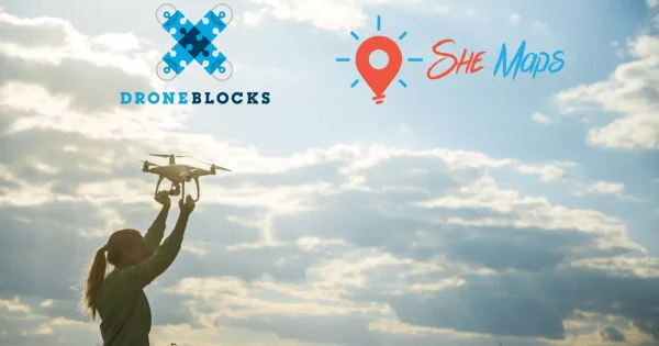 DroneBlocks Announcement a banner showing a woman holding a drone up and She Maps and DroneBlocks logos