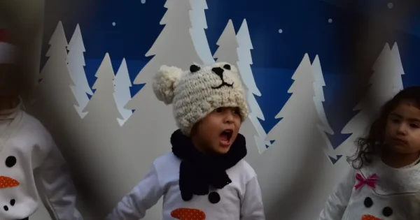 a kid performing a song during a holiday program