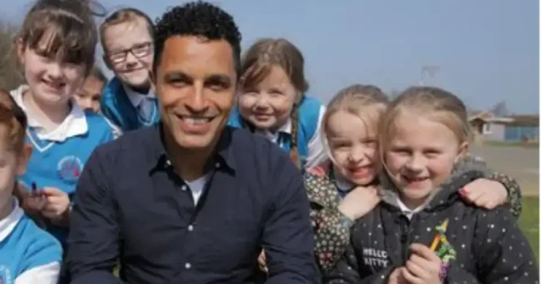 a group of school girls with their male teacher outdoors